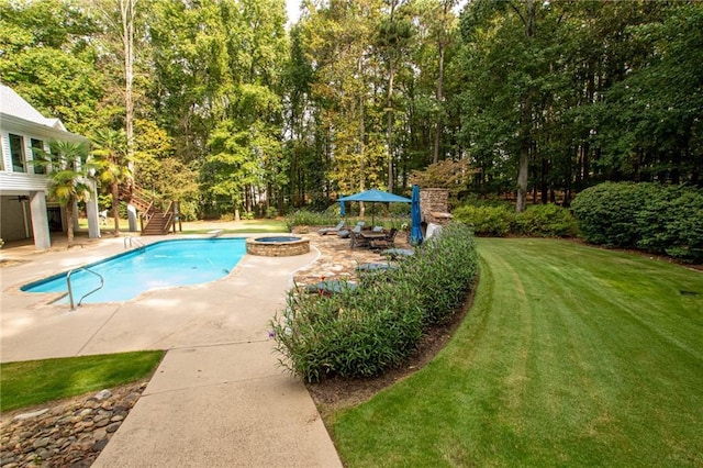 view of pool with a patio, stairway, a yard, a pool with connected hot tub, and a fire pit