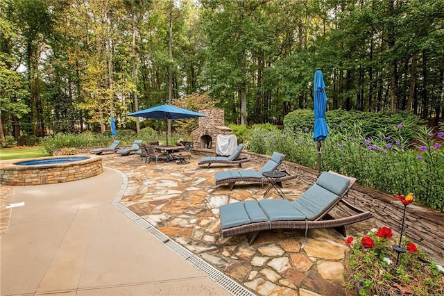 view of patio / terrace with an in ground hot tub