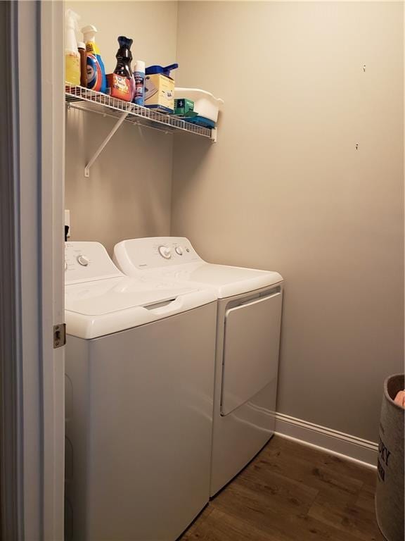 laundry area featuring washing machine and dryer and dark wood-type flooring