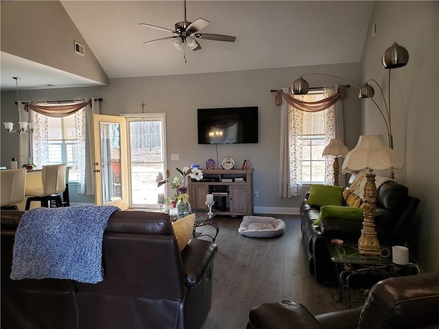 living room with ceiling fan, vaulted ceiling, and hardwood / wood-style floors