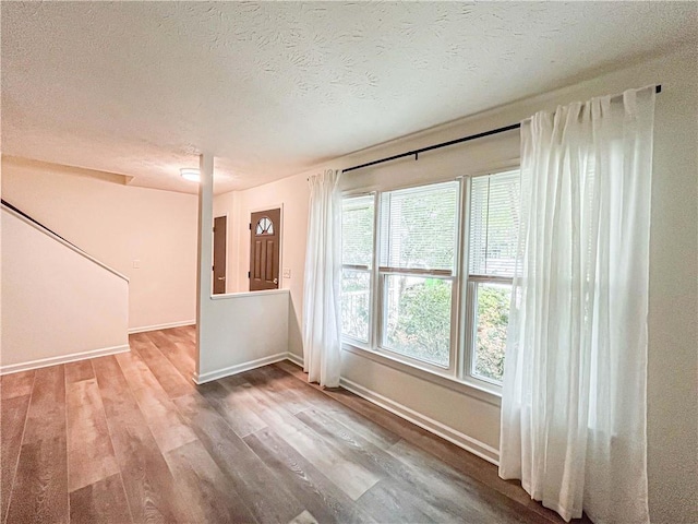3150 Stratford Green Pl, Avondale Estates, GA 30002 - unfurnished living room featuring wood finished floors and a textured ceiling