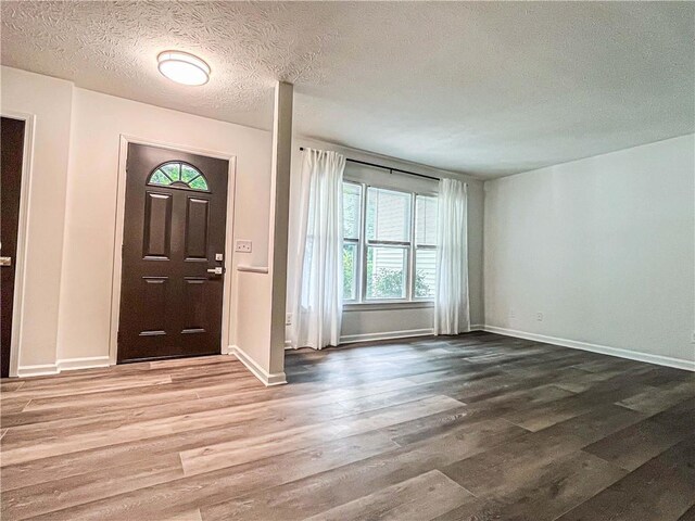 3150 Stratford Green Pl, Avondale Estates, GA 30002 - foyer entrance with wood finished floors and a textured ceiling