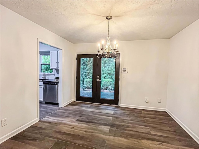 3150 Stratford Green Pl, Avondale Estates, GA 30002 - entryway featuring a chandelier, dark wood-style flooring, and a textured ceiling