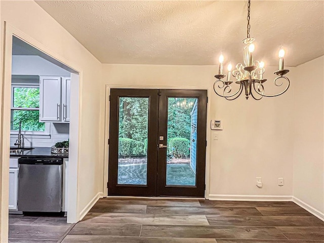 3150 Stratford Green Pl, Avondale Estates, GA 30002 - doorway featuring a chandelier, dark wood-type flooring, a textured ceiling, and french doors