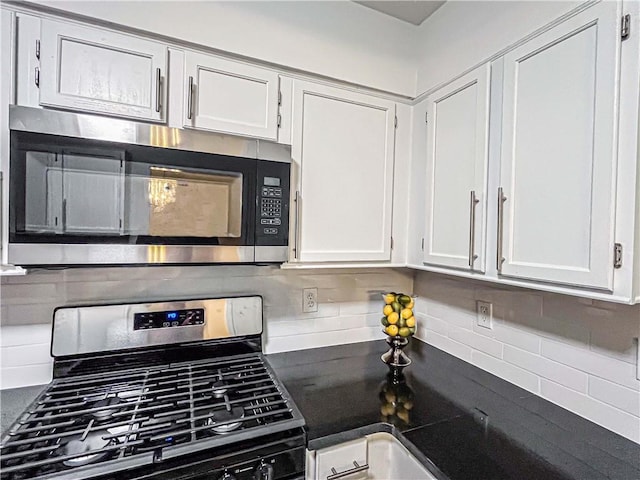 3150 Stratford Green Pl, Avondale Estates, GA 30002 - kitchen featuring stainless steel appliances, decorative backsplash, white cabinetry, and dark countertops