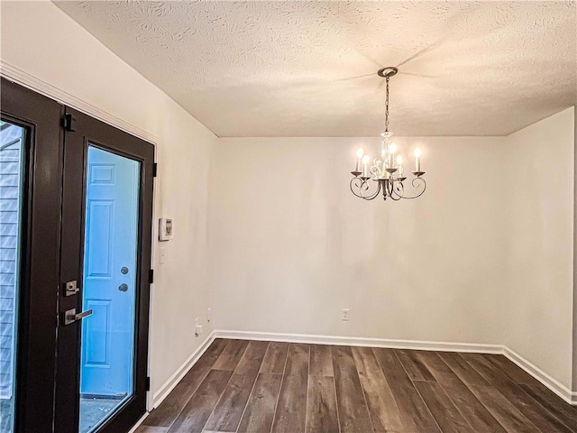 3150 Stratford Green Pl, Avondale Estates, GA 30002 - unfurnished dining area with dark wood-type flooring, a chandelier, and a textured ceiling