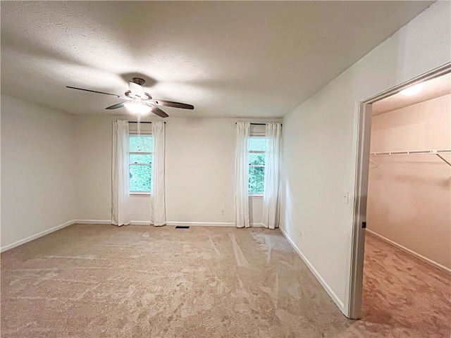 3150 Stratford Green Pl, Avondale Estates, GA 30002 - unfurnished bedroom featuring carpet, a ceiling fan, a walk in closet, and a textured ceiling