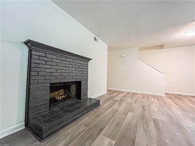 3150 Stratford Green Pl, Avondale Estates, GA 30002 - unfurnished living room with wood finished floors and a brick fireplace