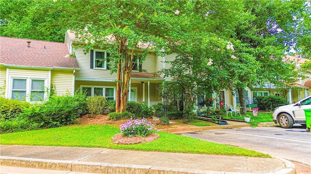 3150 Stratford Green Pl, Avondale Estates, GA 30002 - view of front facade featuring uncovered parking, covered porch, and a front yard