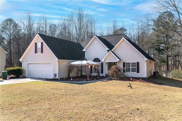 view of front of house with a garage, a gazebo, and a front lawn