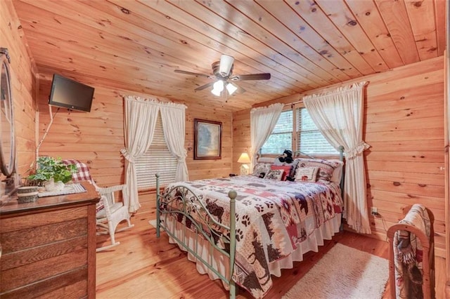 bedroom with ceiling fan, wood-type flooring, and wooden ceiling