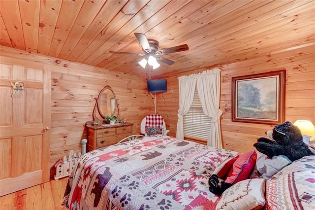 bedroom with wooden ceiling, ceiling fan, wood walls, and wood-type flooring