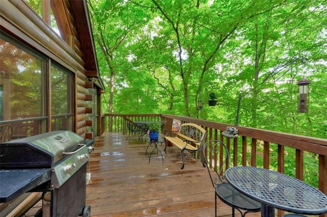 wooden deck with a grill