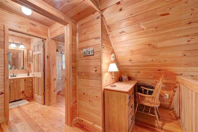 bathroom featuring hardwood / wood-style floors, vanity, wooden walls, and wood ceiling