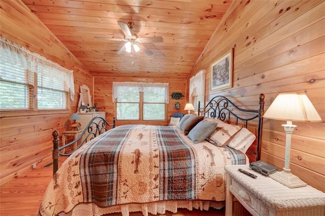 bedroom featuring wooden ceiling, wooden walls, ceiling fan, and lofted ceiling