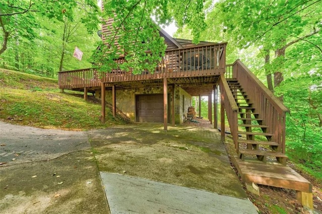 652 Fox Run Dr, Blue Ridge, GA 30513 - exterior space featuring driveway, stairway, a wooden deck, and an attached garage