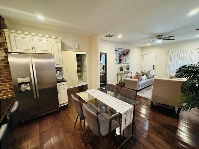 dining space featuring ceiling fan and dark hardwood / wood-style flooring