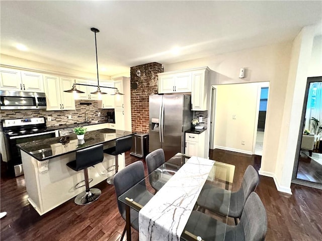 dining space with sink and dark hardwood / wood-style floors