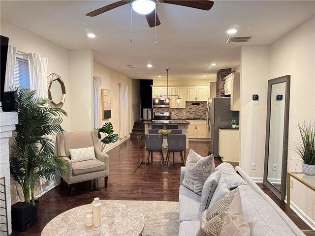 kitchen featuring sink, white cabinetry, decorative light fixtures, stainless steel appliances, and backsplash