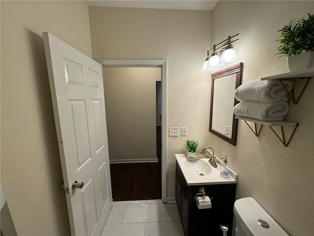 bathroom featuring vanity and toilet