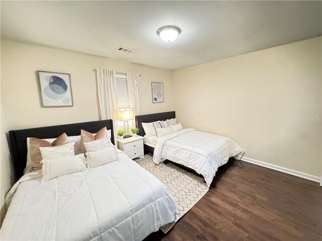 bedroom featuring dark hardwood / wood-style floors and ceiling fan