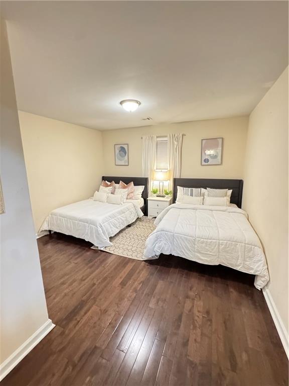 bedroom with dark wood-type flooring and ceiling fan