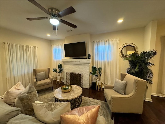 living room with ceiling fan and dark hardwood / wood-style floors