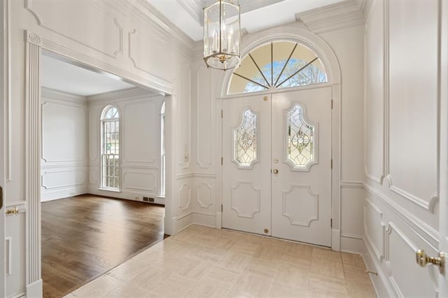 1585 Lazy River Ln, Sandy Springs, GA 30350 - entryway featuring a chandelier, visible vents, ornamental molding, and a decorative wall