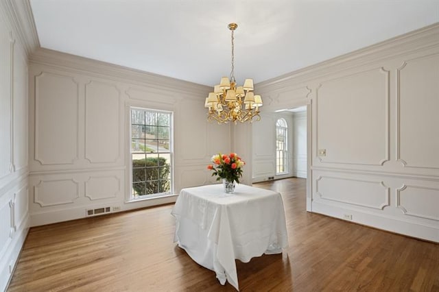 1585 Lazy River Ln, Sandy Springs, GA 30350 - dining space with a decorative wall, a healthy amount of sunlight, visible vents, and a notable chandelier
