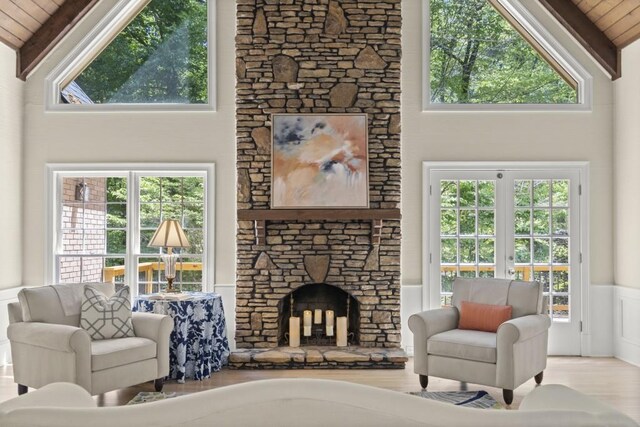 1585 Lazy River Ln, Sandy Springs, GA 30350 - living room with a wainscoted wall, wooden ceiling, vaulted ceiling with beams, wood finished floors, and a stone fireplace