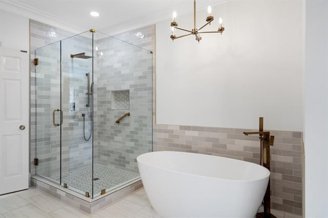 1585 Lazy River Ln, Sandy Springs, GA 30350 - bathroom featuring an inviting chandelier, a soaking tub, a stall shower, and tile walls