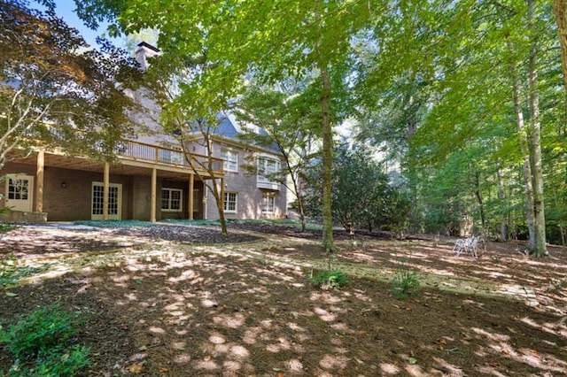 1585 Lazy River Ln, Sandy Springs, GA 30350 - view of yard featuring a deck and french doors