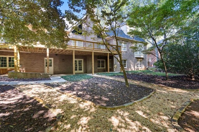 1585 Lazy River Ln, Sandy Springs, GA 30350 - back of property with a chimney, a deck, a patio area, and french doors