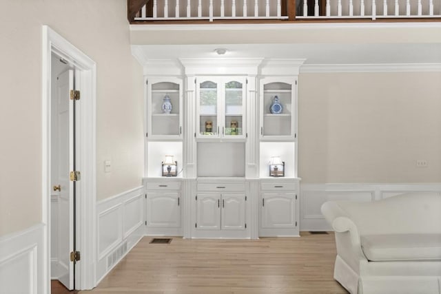 1585 Lazy River Ln, Sandy Springs, GA 30350 - sitting room with light wood-type flooring, visible vents, a decorative wall, ornamental molding, and wainscoting