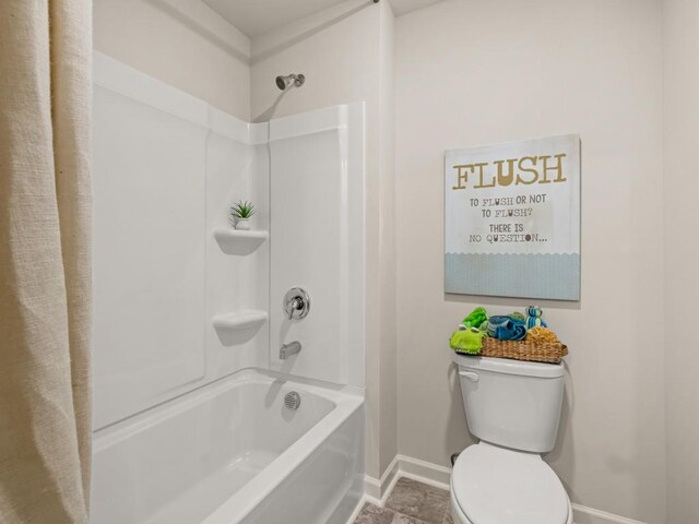 full bathroom with baseboards, tub / shower combination, and toilet