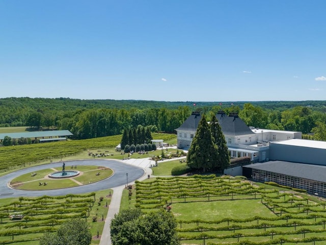 birds eye view of property featuring a rural view and a wooded view