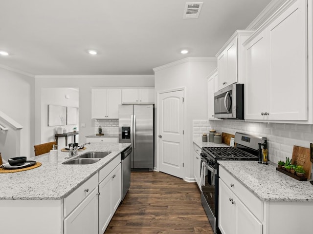 kitchen featuring white cabinetry, appliances with stainless steel finishes, a sink, and visible vents