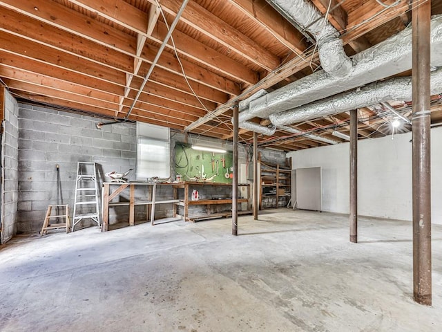 unfinished basement featuring a workshop area
