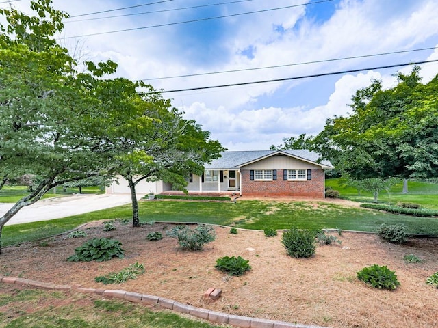 ranch-style house with brick siding, driveway, a front yard, and a garage