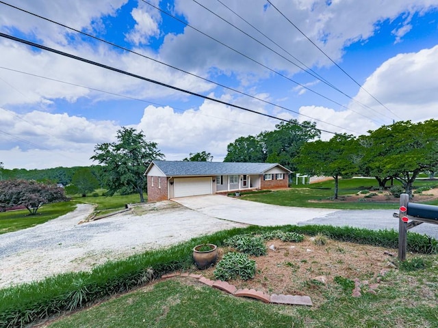 ranch-style house with driveway, an attached garage, a front lawn, and brick siding