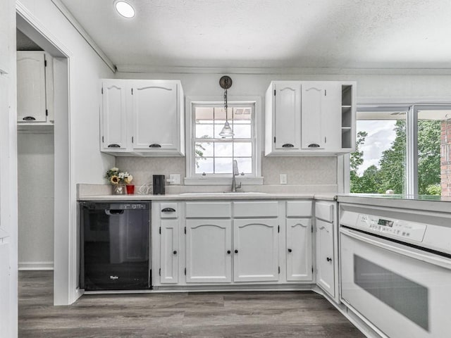 kitchen with dishwasher, oven, white cabinetry, a sink, and recessed lighting