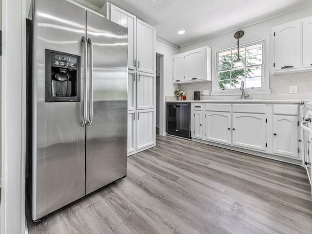 kitchen featuring stainless steel fridge, dishwasher, a sink, white cabinetry, and recessed lighting