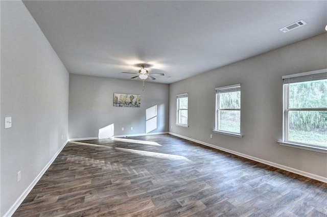 empty room featuring ceiling fan and dark wood-type flooring