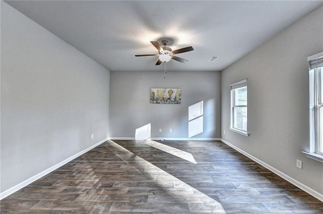 empty room with ceiling fan and dark wood-type flooring