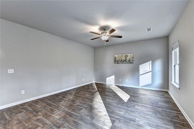 spare room featuring ceiling fan and dark hardwood / wood-style flooring