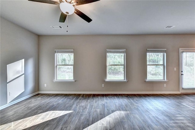 unfurnished room featuring ceiling fan and dark hardwood / wood-style floors