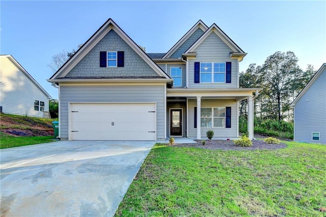 craftsman inspired home featuring a garage and a front yard