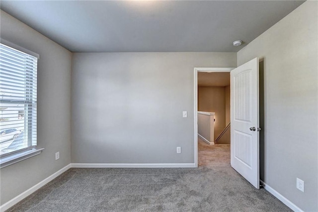 spare room with plenty of natural light and light carpet