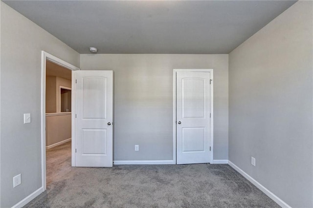 unfurnished bedroom featuring light carpet