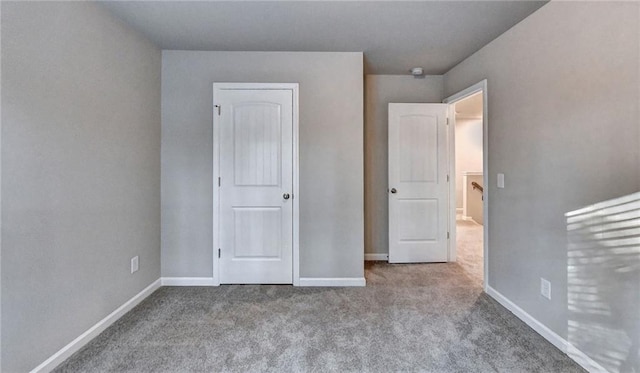 unfurnished bedroom featuring light carpet